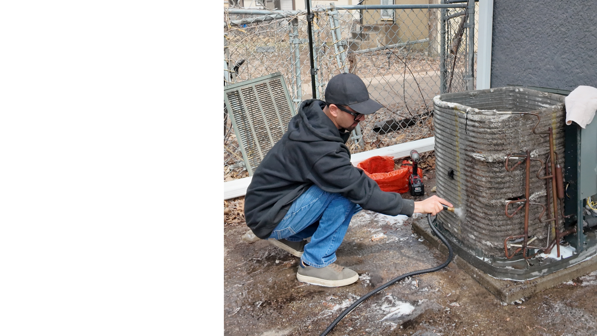 Justin Fodor pressure washing AC condenser coils — clean vs dirty contrast visible